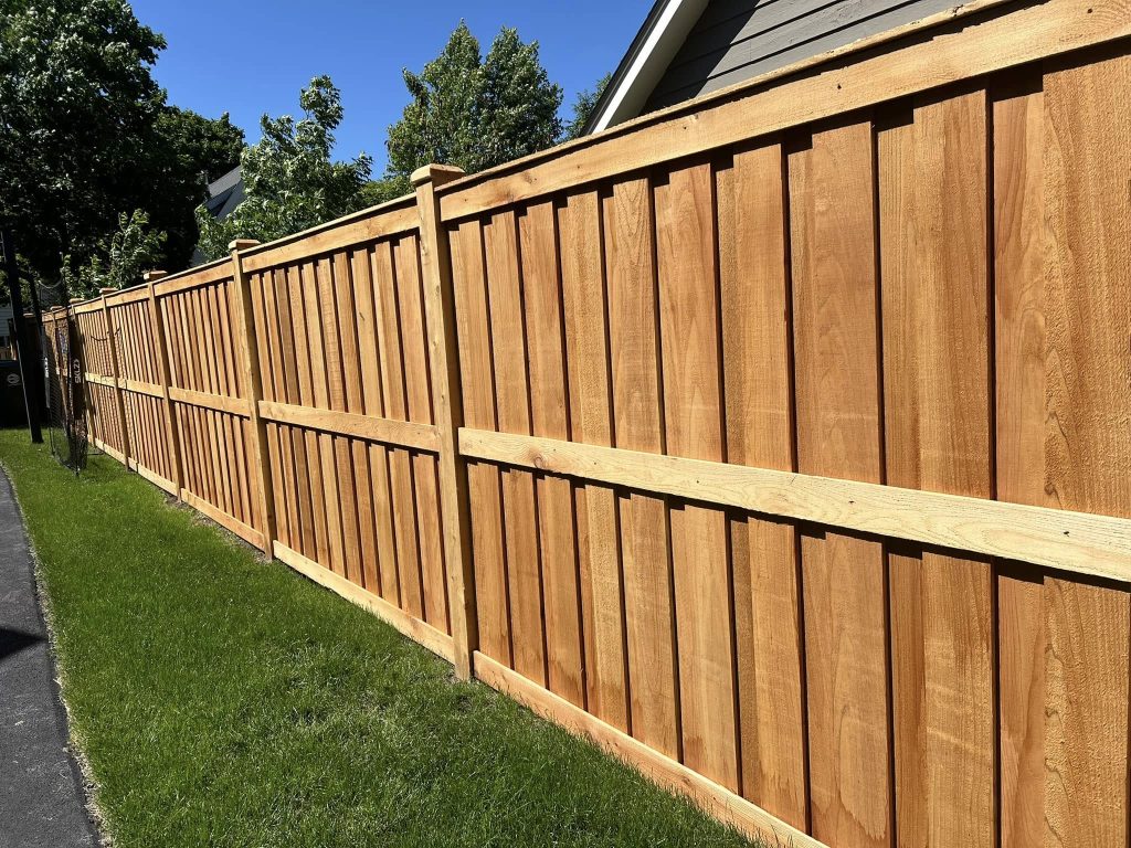 Close-up view of high-quality wood privacy fence showcasing smooth finish, consistent grain, and sturdy construction — ideal for homeowners seeking timeless elegance and long-term value